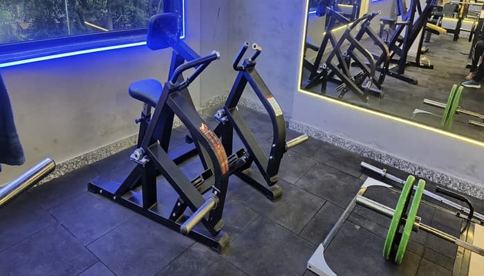 Seated row machine and Olympic barbells
